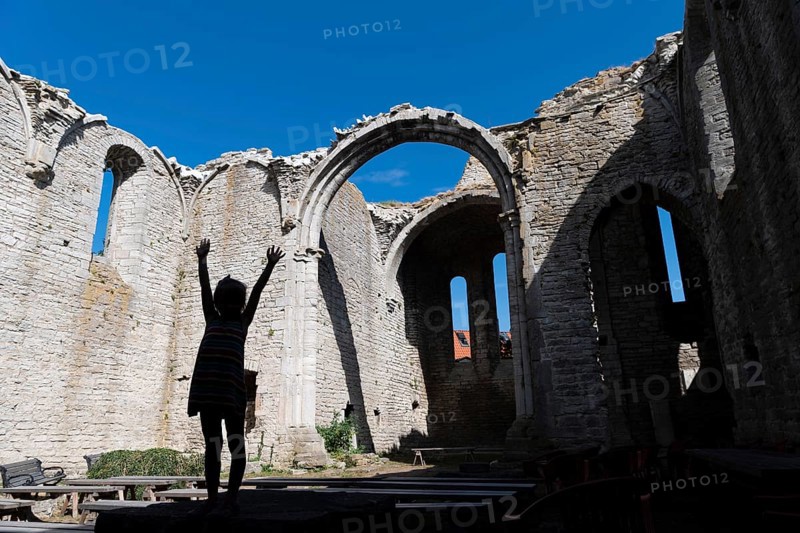 Silhouette of a girl with outstretched arms, church ruins, Hanseatic city of Visby, UNESCO World Heritage Site, Gotland Island, Sweden, Europe