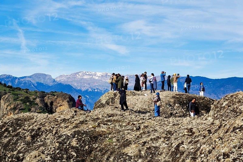 Group of tourists on rocks, enjoying the view, Meteora, blue sky, Thessaly, Greece, Europe