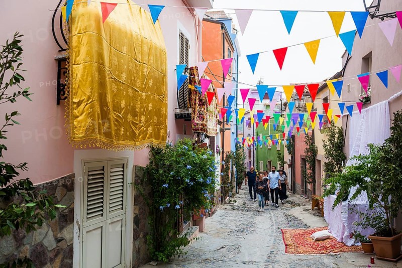 Decorated alley and celebrating people, feast of the Madonna of Regnos Altos, Bosa, district of Oristano, Sardinia, Italy, Europe