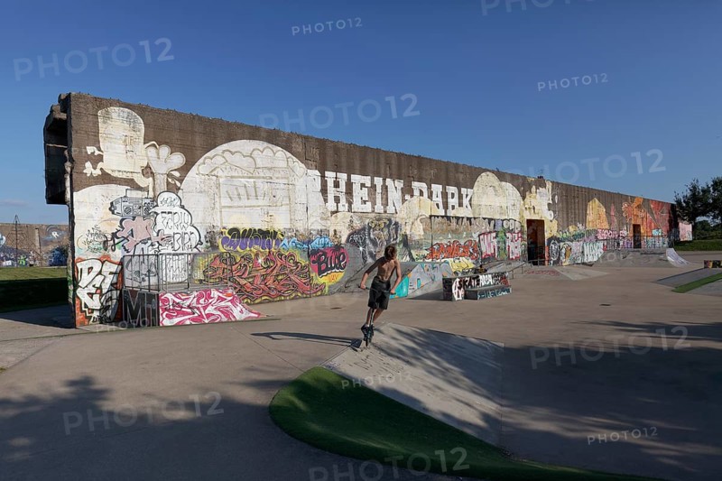 Rehinpark Duisburg, skate park with graffiti wall, boy jumping with stunt scooter, Duisburg, North Rhine-Westphalia, Germany, Europe