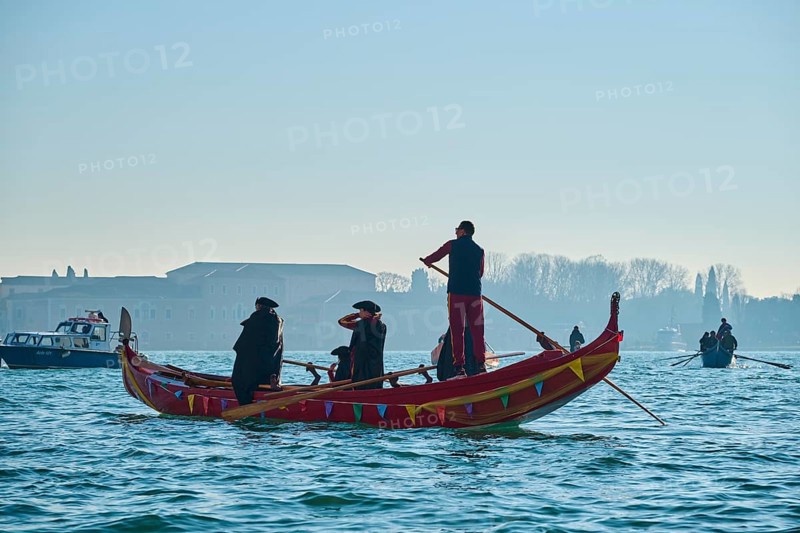 Wild carnival hustle and bustle on the 'Canal Grande' with decorated boats and masked people in Venice, Italy, Europe