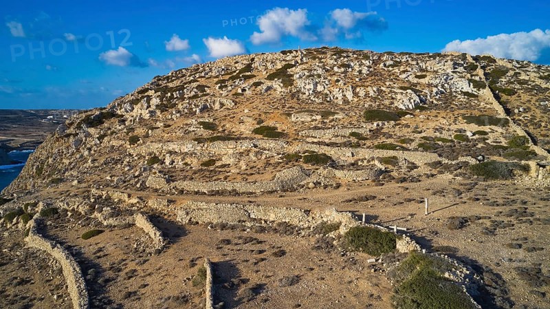 Drone image, Archaeological excavation site, A rocky hill under blue sky with visible dry stone walls, Ruins of an acropolis, Acropolis hill, Arkasa, West coast, Karpathos, Dodecanese, Greek Islands, Greece, Europe
