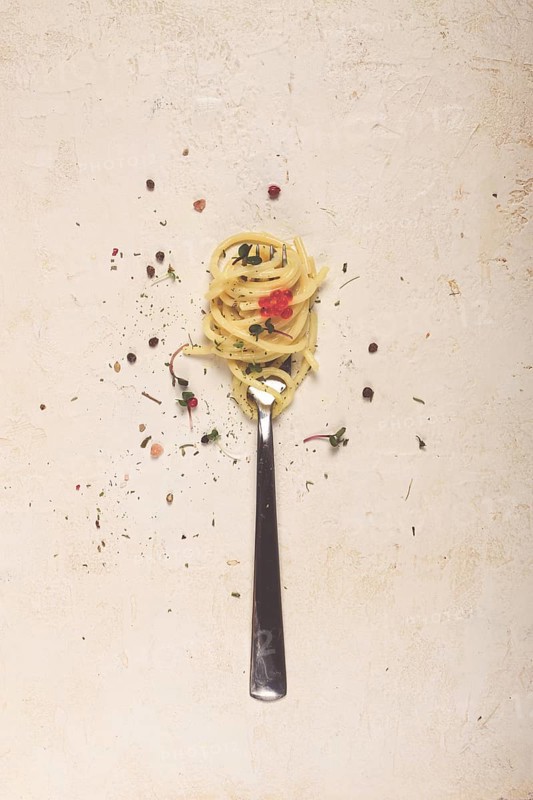 Spaghetti strung on a fork, on the table, dish concept, dish background, top view