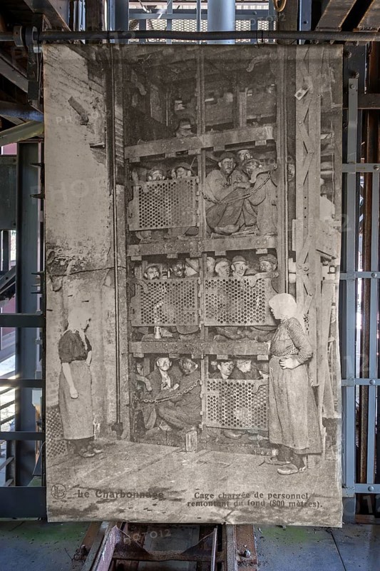 1920s old photograph showing coal miners in coal mining lift cage, elevator at Le Bois du Cazier coal mine museum, Marcinelle, Hainaut, Belgium, Europe