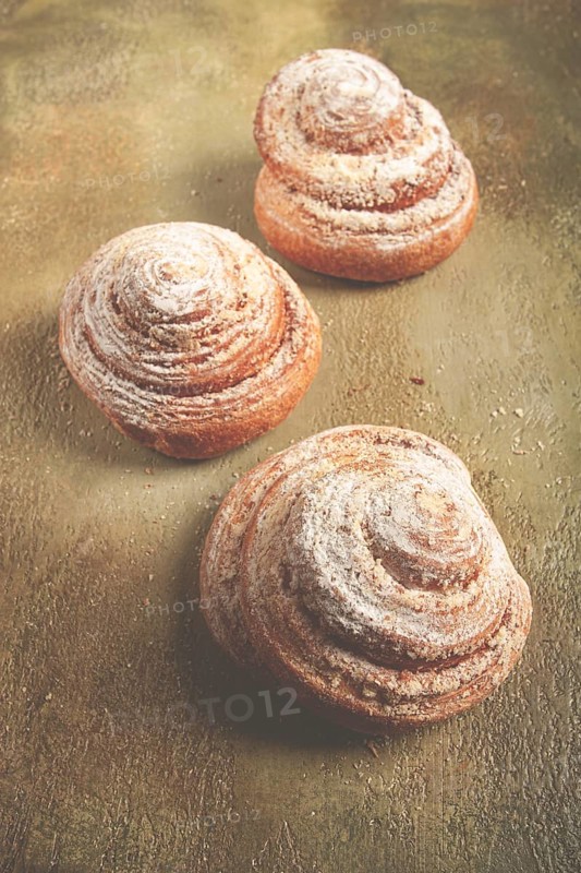 Bakery product, lemon twist, with white glaze, sweet bun, muffin, pastries, top view, no people