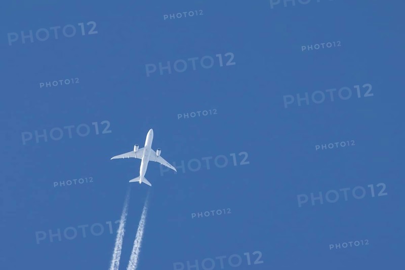 Boeing 787-8 Dreamliner jet passenger aircraft of Aeromexico flying in a blue sky with a vapor trail or contrail behind, England, United Kingdom, Europe