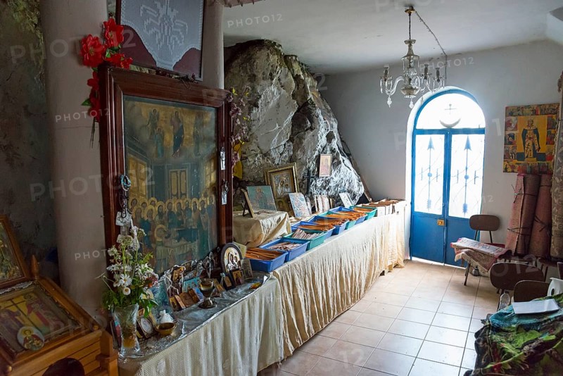 Room with religious pictures and icons on a long table next to a door, Rock Church of Smerna, Church of the Assumption of the Virgin Mary, Panagia Smerniotissa, Elis, Peloponnese, Greece, Europe