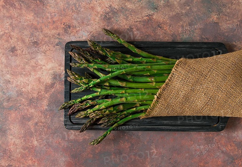 Bouquet of fresh asparagus, on an abstract background, top view, rustic, no people