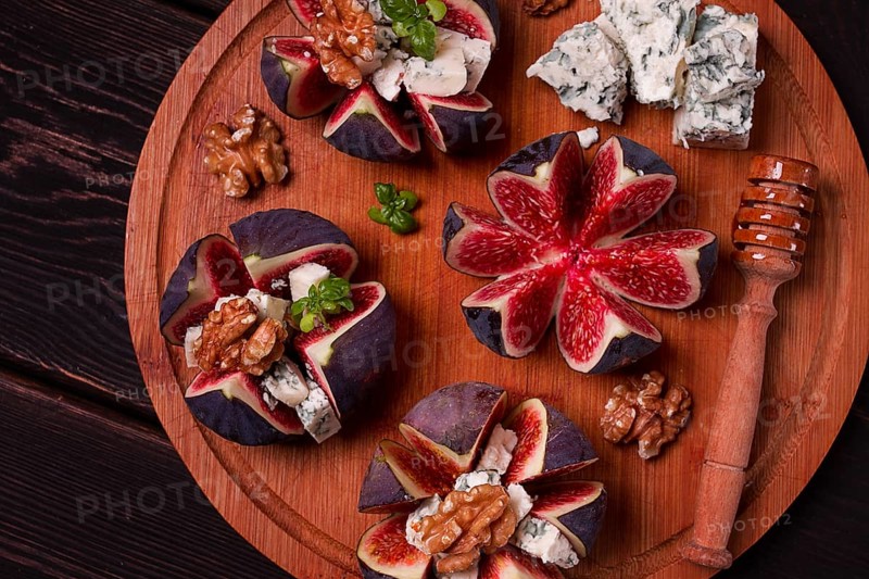 Appetizer, Figs with blue cheese, walnut, honey, on a wooden board, top view, close-up, no people