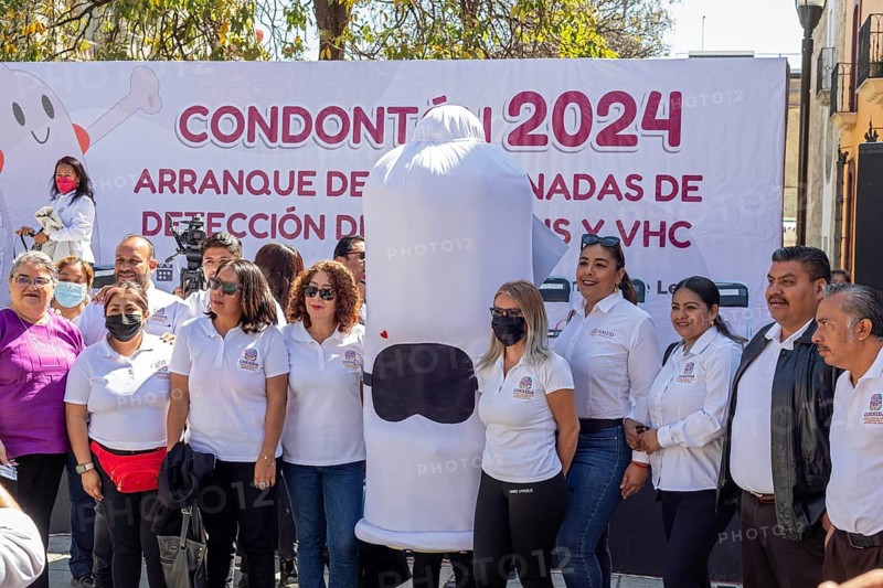 Oaxaca, Mexico, Health workers pose for photos with a person wearing a condom costume as part of their campaign against sexually-transmitted diseases. Afterwards, they walked the streets, handing out free condoms, Central America