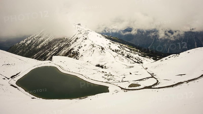 Onset of winter in May, Riezler Alpsee, an artificial lake, snow pond, feeds the snow cannons that provide the slopes of the Fellhorn and Kanzelwand cable cars with snow, Allgäu Alps, Vorarlberg, Austria, Europe