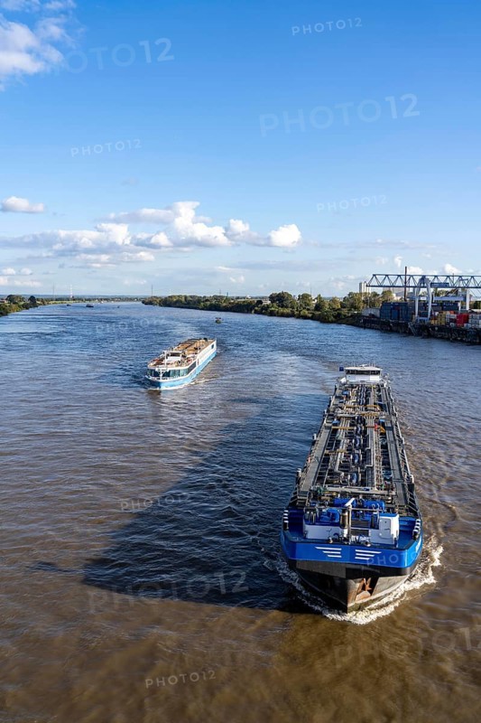Cargo ship, tanker and river cruise ship on the Rhine, near Krefeld-Ürdingen, North Rhine-Westphalia, Germany, Europe