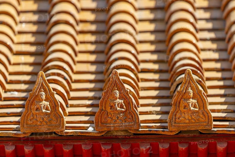 Roof decoration on the Uposatha Hall, Ubosot, the roof is staggered in three tiers and covered with rows of golden yellow glazed Chinese tiles, the last tile of each row at the eaves represents a heavenly angel offering the traditional Thai obeisance Wai to the viewer with folded hands, Wat Benchamabophit, marble temple, Bangkok, Thailand, Asia