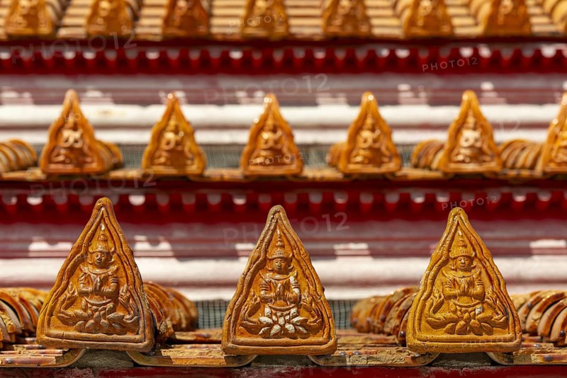 Roof decoration on the Uposatha Hall, Ubosot, the roof is staggered in three tiers and covered with rows of golden yellow glazed Chinese tiles, the last tile of each row at the eaves represents a heavenly angel offering the traditional Thai obeisance Wai to the viewer with folded hands, Wat Benchamabophit, marble temple, Bangkok, Thailand, Asia