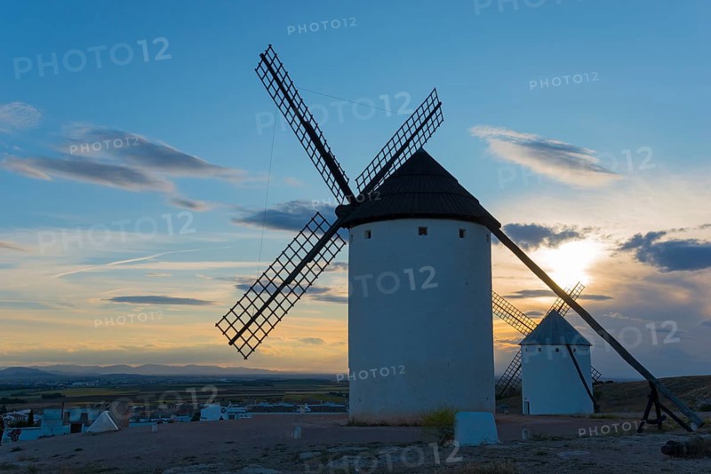 Windmills at dusk with a bright sky in the background, Campo de Criptana, Ciudad Real province, Castilla-La Mancha, Don Quixote Route, Spain, Europe
