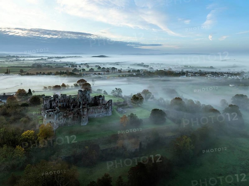 Raglan Castle in the fog at dawn from a drone, Monmouthshire, Wales, England, United Kingdom, Europe