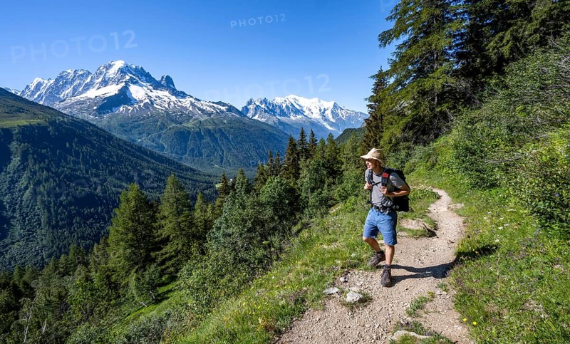 Mountaineer on hiking trail, mountain panorama with glaciated mountain peaks, Aiguille Verte with Aiguille du Midi and Mont Blanc, hike to Aiguillette des Posettes, Chamonix, Haute-Savoie, France, Europe
