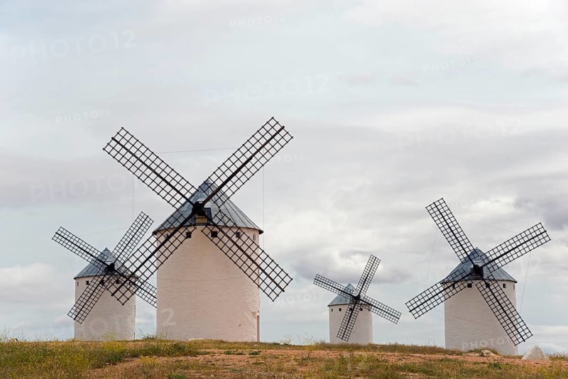 Historic windmills with a cloudy atmosphere. The white colour of the mills contrasts with the grey sky, windmills, Campo de Criptana, province of Ciudad Real, Castilla-La Mancha, Route of Don Quixote, Spain, Europe