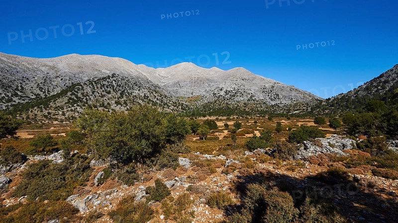 Vast mountain landscape with clear blue sky and green valley, under sunny weather, Lefka Ori, White Mountains, Mountain massif, West, Crete, Greece, Europe