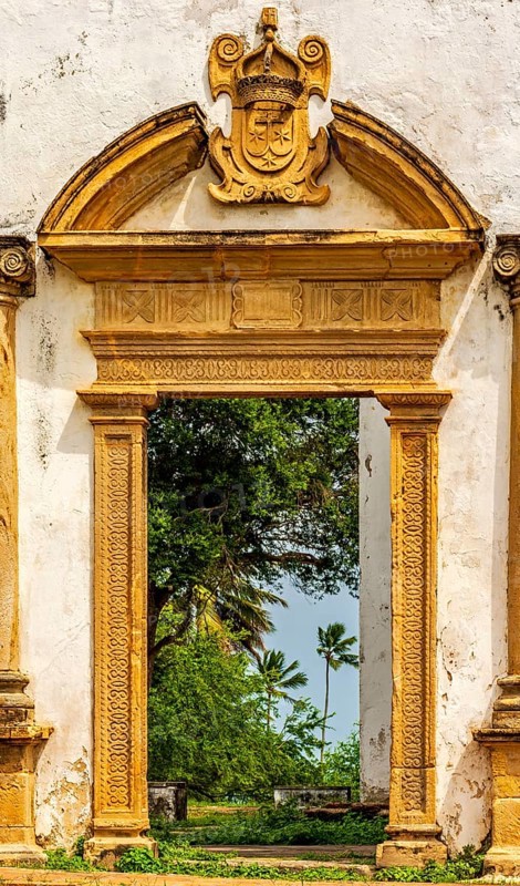 Baroque church portal overlooking tropical vegetation and ruins in the city of Olinda in Pernambuco, Olinda, Pernambuco, Brazil, South America