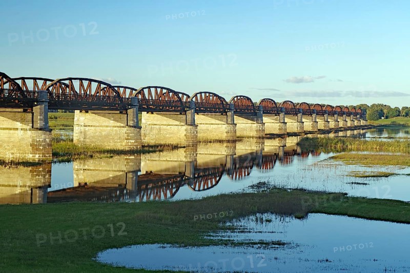 Long, arched stone bridge reflected in the calm river water under a clear sky, autumn, Elbe, Skywalk, Dömitzer railway bridge, Langendorf, Wendland, Lower Saxony, Germany, Europe