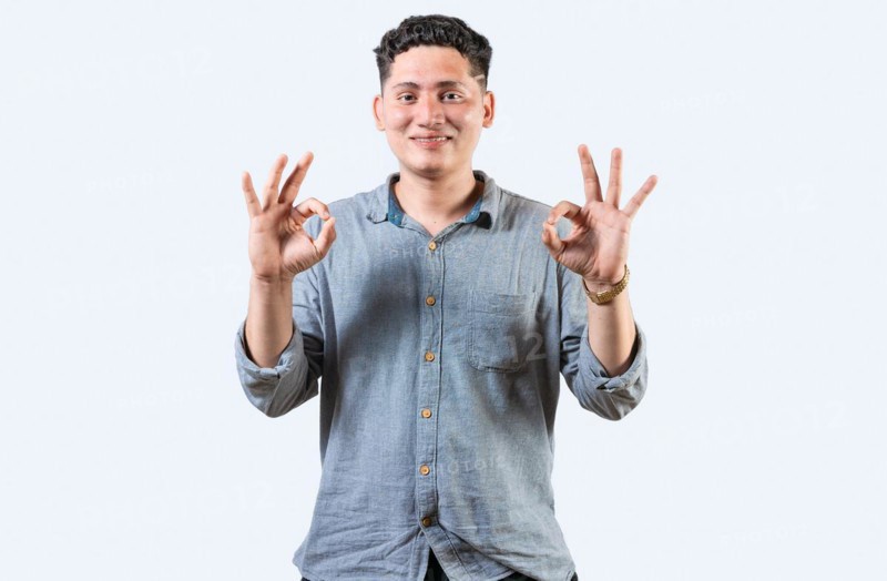 Interpreter person gesturing OK in sign language. Smiling young man gesturing APPROVED in sign language