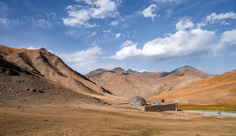 Historic caravanserai Tash Rabat from the 15th century, with yellow hills, Atbashy district in the Naryn region, Kyrgyzstan, Asia