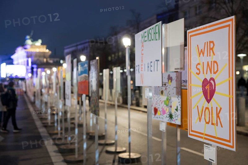Signs painted by children with the words Menschen machen Freiheit and Wir sind 1 Volk to mark the 35th anniversary of the fall of the Berlin Wall, 8 November 2024