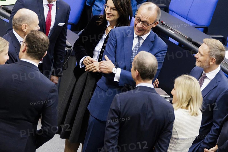 Olaf Scholz (SPD), Federal Chancellor, greets Friedrich Merz, CDU, and Christian Lindner in plenary in front of the session in the German Bundestag, Berlin, 13 November 2024