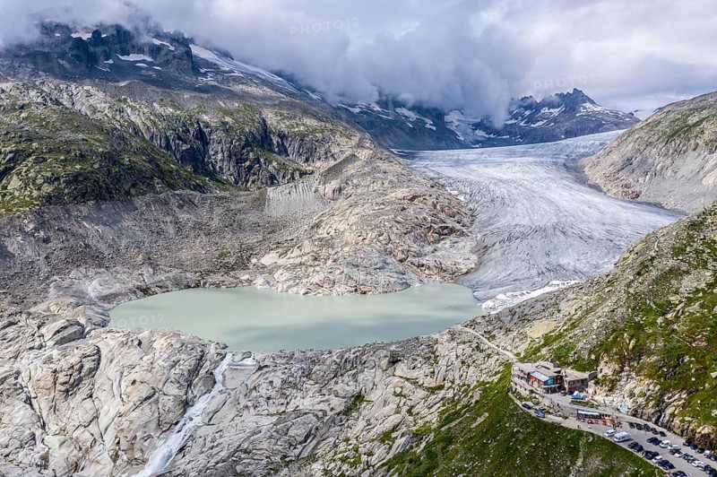 Drone shot of melting Rhone glacier, glacial lake, origin of Rhone river, Switzerland, Europe