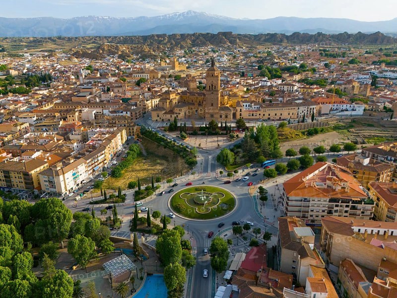 Aerial view of a city with historical centre, roundabout and surrounding landscape, mountains in the background, aerial view, cathedral, Catedral de la Encarnación de Guadix, Guadix, Sierra Nevada, Granada, Andalusia, Spain, Europe