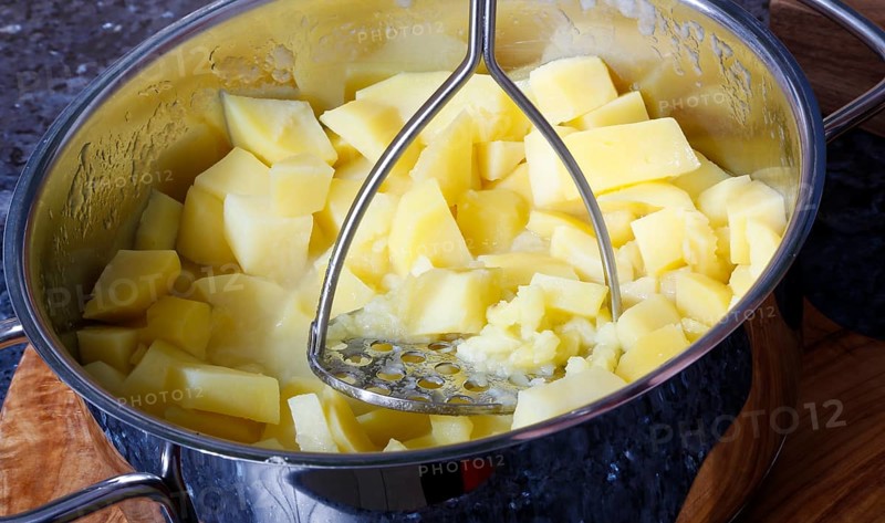 German cuisine, preparation of potatoes for sauerbraten with mashed potatoes, potato masher, potato ricer, main course, pot, grandmother's kitchen, regional, home cooking, traditional cuisine reinterpreted, food photography, studio, Germany, Europe