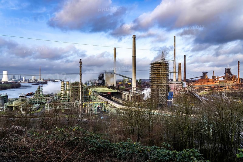 The Thyssenkrupp Steel steelworks in Duisburg-Marxloh, on the Rhine, coking plant unloading tower, blast furnaces 1 and 2, right, STEAG Walsum coal-fired power station, left, North Rhine-Westphalia, Germany, Europe