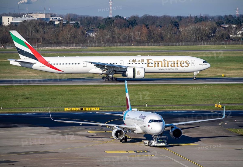 Emirates Boeing 777 aircraft after landing at Düsseldorf Airport, main runway 05R/23L, South, DUS, Eurowings Airbus being towed to a parking position, North Rhine-Westphalia, Germany, Europe