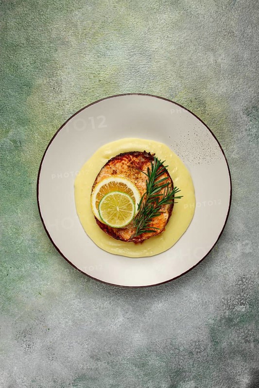 Salmon steak, fried, mashed potatoes, top view, rosemary, lemon and lime, homemade, one serving, no people