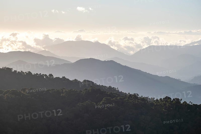 View of hills with cloud forest, in the evening light, Dramatic clouds between the mountains, Province of San José, Costa Rica, Central America