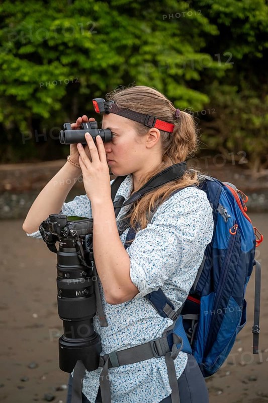 Tourist looking through binoculars, with headlamp and camera in the rainforest, Corcovado National Park, Osa Peninsula, Puntarena Province, Costa Rica, Central America