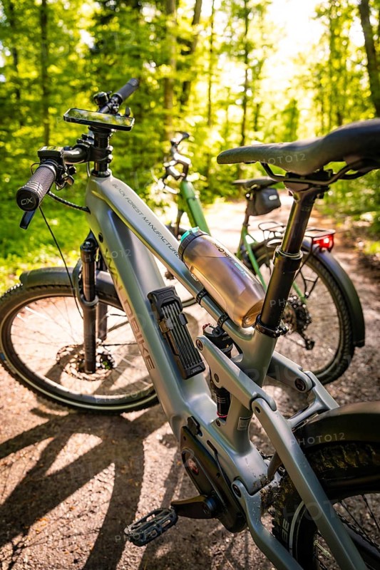 Two e-bikes on a forest path, illuminated by sunbeams in the background, e-bike, forest bike, Calw, district of Calw, Black Forest, Germany, Europe