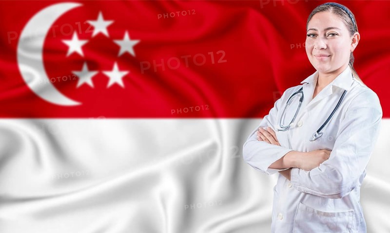 Female doctor on Singapore flag. Doctor with crossed arms on Singapore flag. Singapore Health and Care concept