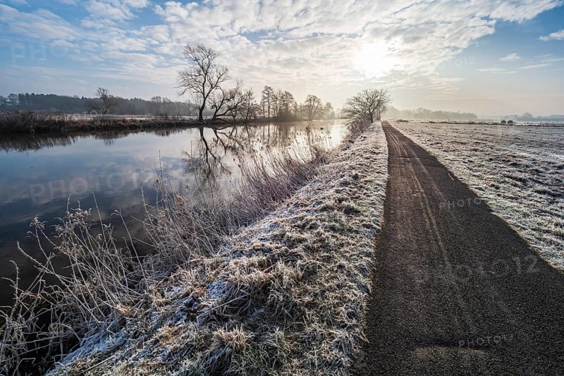 River Aller on a frozen winter day, hiking and cycling path along the river, between Celle and Altencelle, Germany, Europe