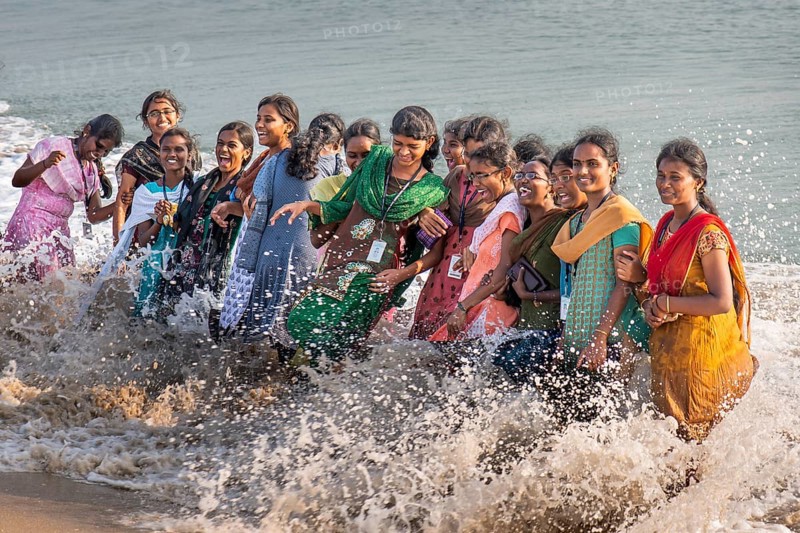Group of laughing young woman standing in the surf, Adam's Bridge, Rameswaram Island, near Rameshwaram or Ramesvaram, Tamil Nadu, South India