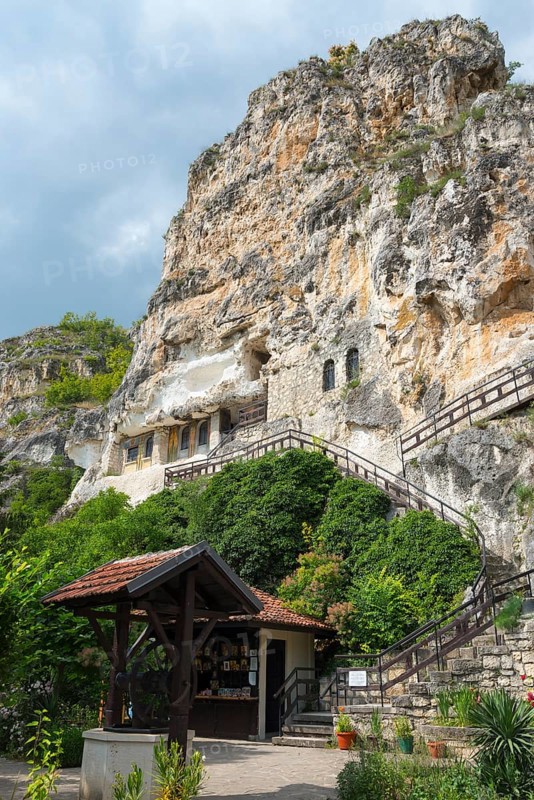 Steep rocky cliff with embedded cave structure and wooden staircase access, Bulgarian Orthodox cave monastery, rock monastery, Basarbowski monastery, Basarbowski, Basarbovo, Basarbovo, Russe, Rhodope Mountains, Bulgaria, Europe