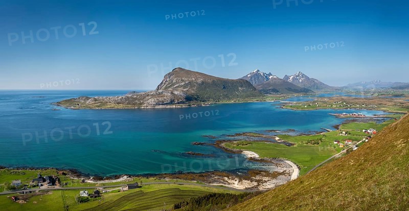 Landscape with sea and mountains, view from Hornsheia to the mountains Offersoykammen and Himmeltindan. Good weather, blue sky. Early summer. Panoramic photo. Hornsheia, Haug, Vestvagoya, Lofoten, Norway, Europe