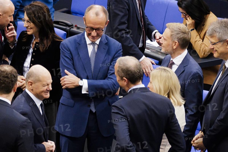 Olaf Scholz (SPD), Federal Chancellor, greets Friedrich Merz, CDU, and Christian Lindner in plenary in front of the session in the German Bundestag, Berlin, 13 November 2024