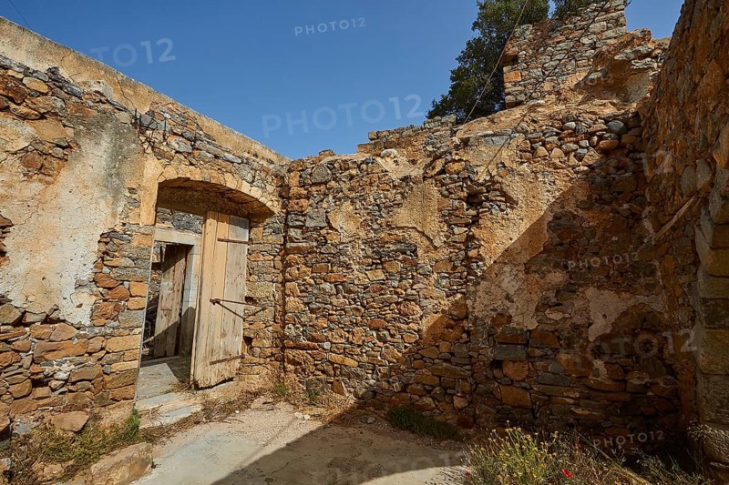 A crumbling building with open doors and stone walls standing in daylight, Venetian Sea Fortress, Leper Island, Spinalonga, Elounda Bay, Mirabello Bay, Eastern Crete, Crete, Greek Islands, Greece, Europe