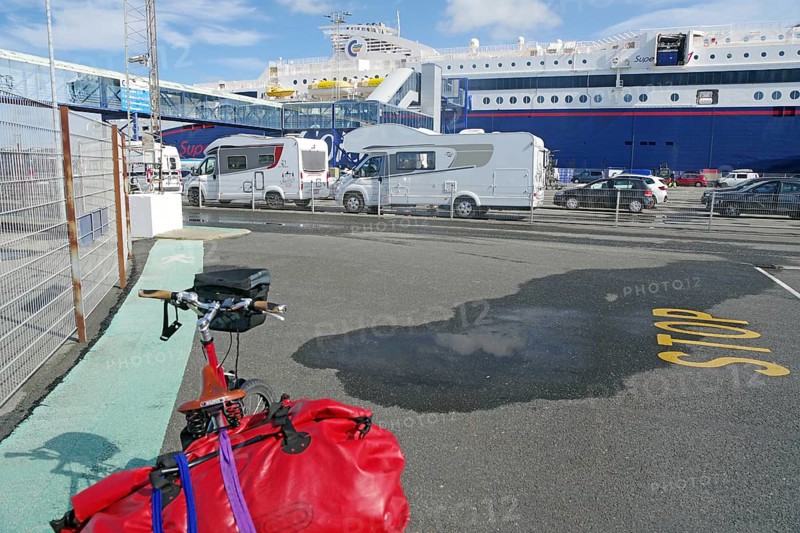 Several motorhomes are parked on a ferry car park, with a large ferry in the background, Transport, Ferry to Norway, Hirtshals, Jutland, Denmark, Europe