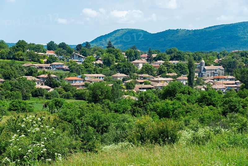 A quiet village surrounded by green hills and trees under a partly cloudy sky, Gagovo, Popovo, Targovishte, Bulgaria, Europe