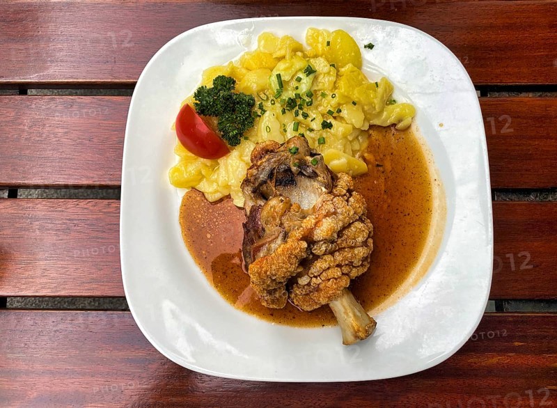 Half pork knuckle, crispy fried, potato salad, tomato, chives, parsley, plate, food, Stuttgart, Baden-Württemberg, Germany, Europe