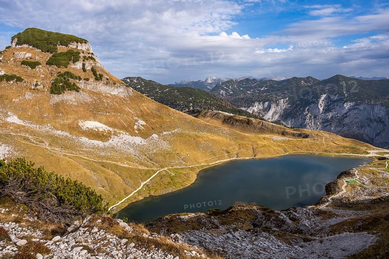 Lake Augstsee and the Atterkogel mountain on the Loser. View of other mountains. Autumn, good weather, blue sky and clouds. Altaussee, Bad Aussee, Ausseer Land, Totes Gebirge, Styria, Upper Austria, Austria, Europe