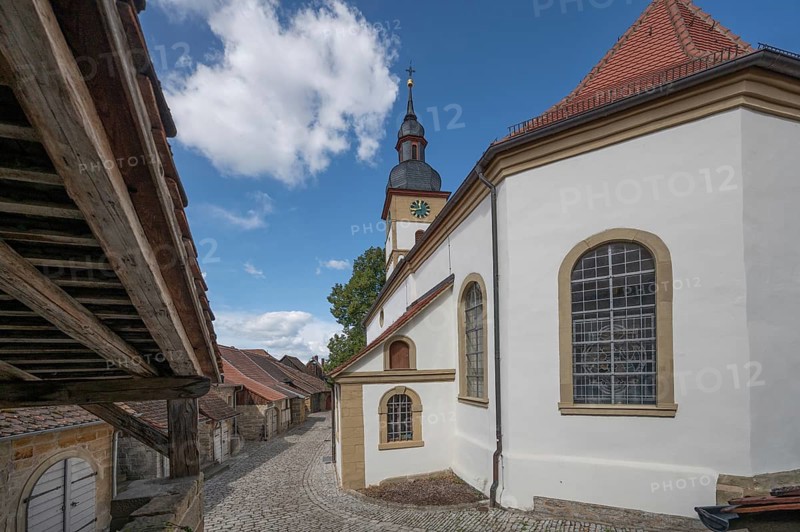 Former so-called Kirchgaden, barns, on the right the Protestant St John's Church in the historic fortified church, Hüttenheim, Lower Franconia, Bavaria, Germany, Europe